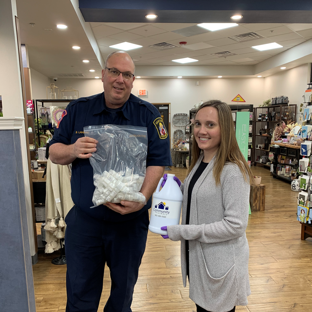 Community Pharmacy donating hand sanitizer to their local police department