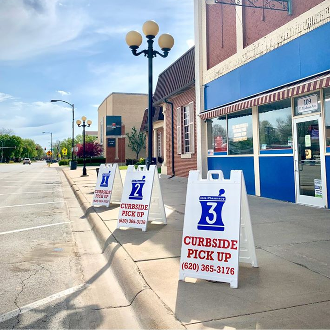 Curbside pickup signage outside Iola Pharmacy
