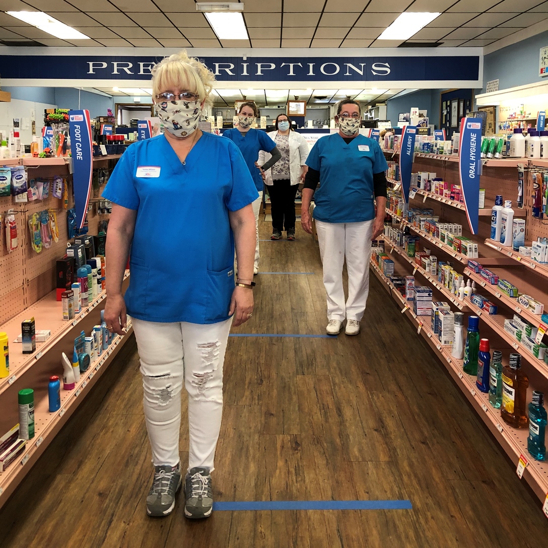The staff at J & B Drug Store demonstrating social distancing