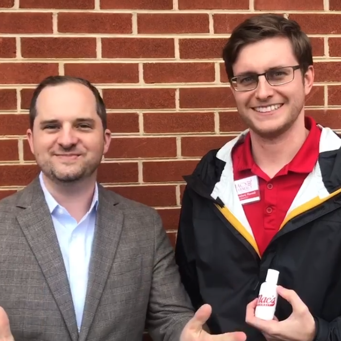 Mike and Matthew from Mac's Pharmacy showing the hand sanitizer they are compounding in house