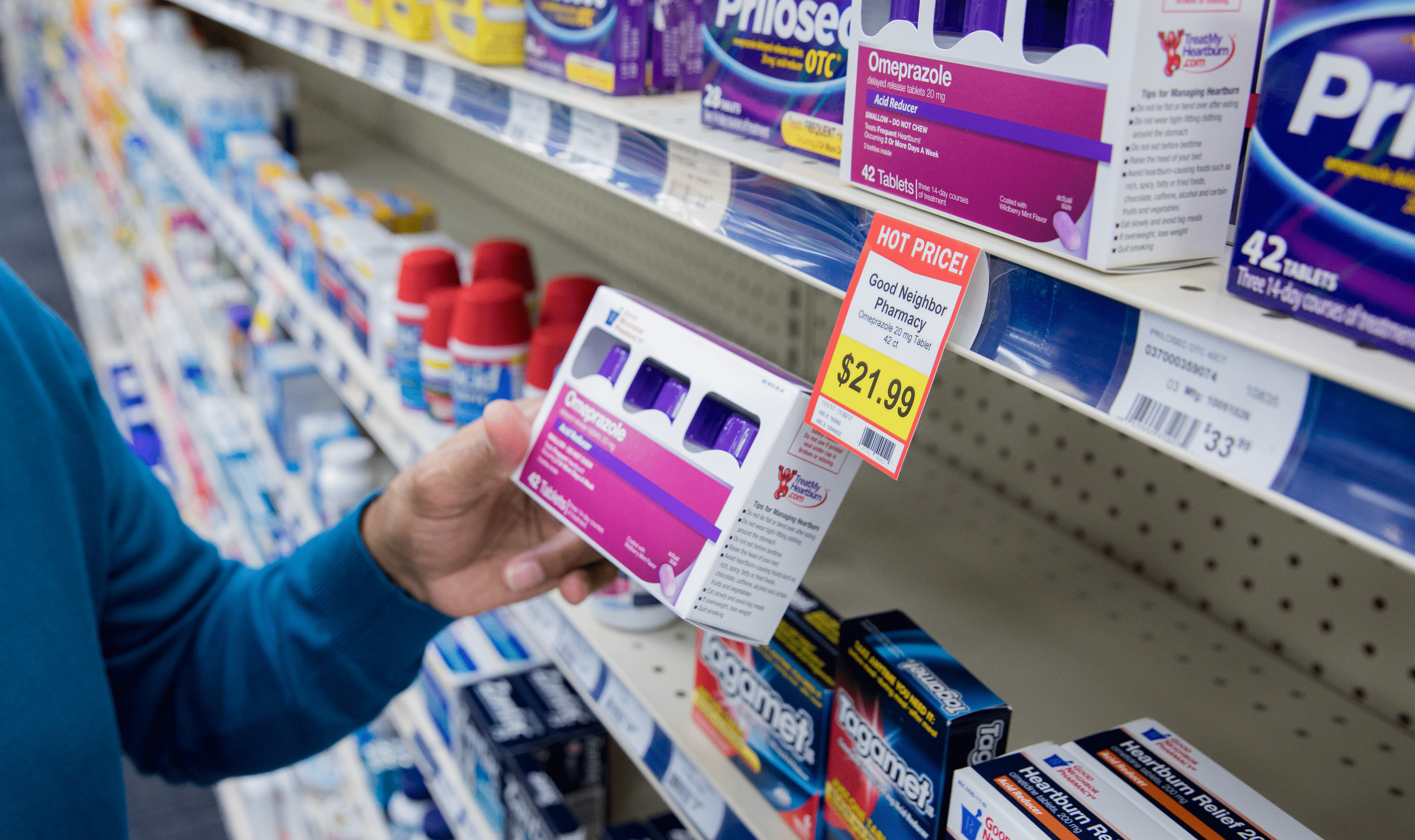 A man shopping for over-the-counter medication in an independent pharmacy
