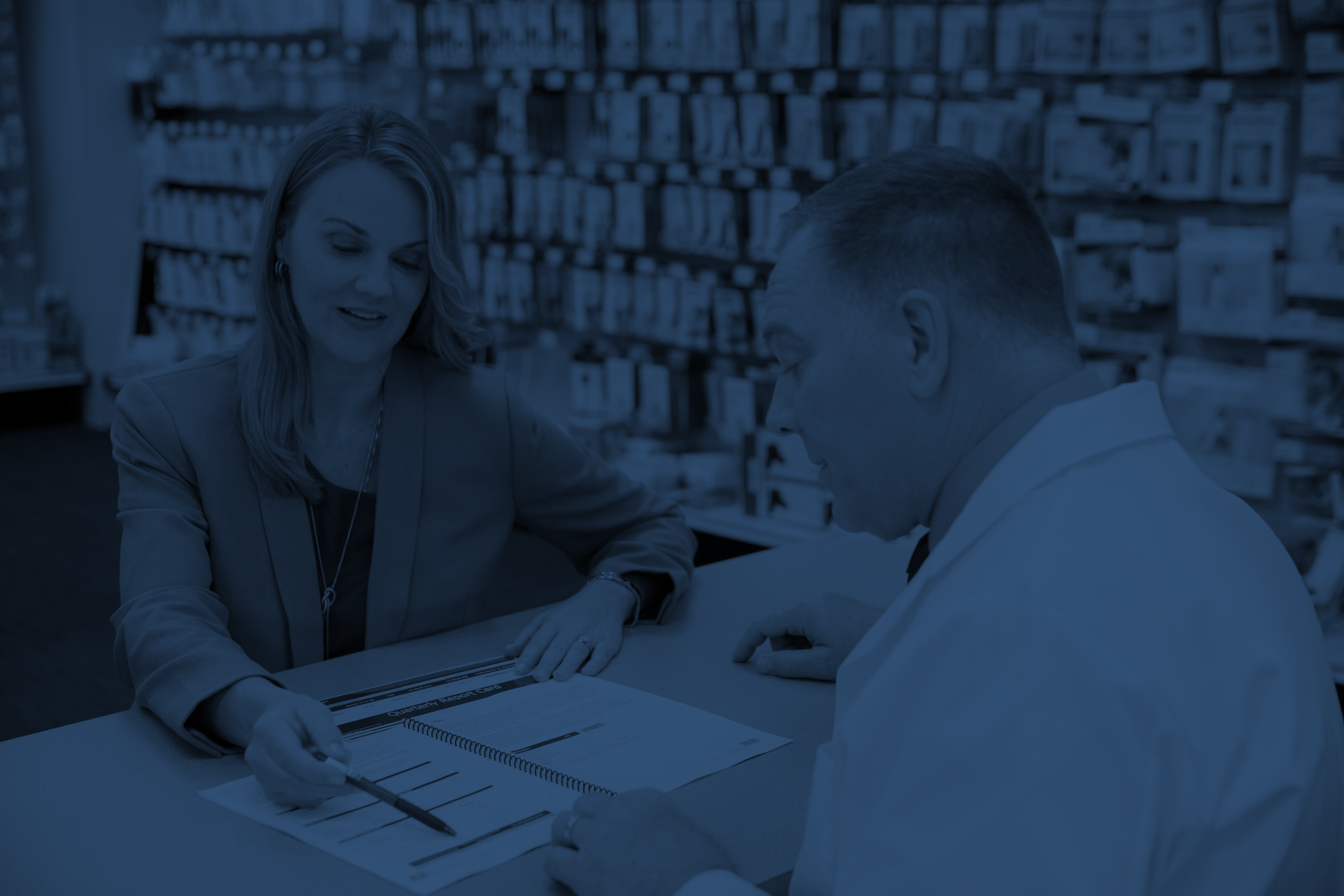 A business coach helps a pharmacist improve his pharmacy's business performance