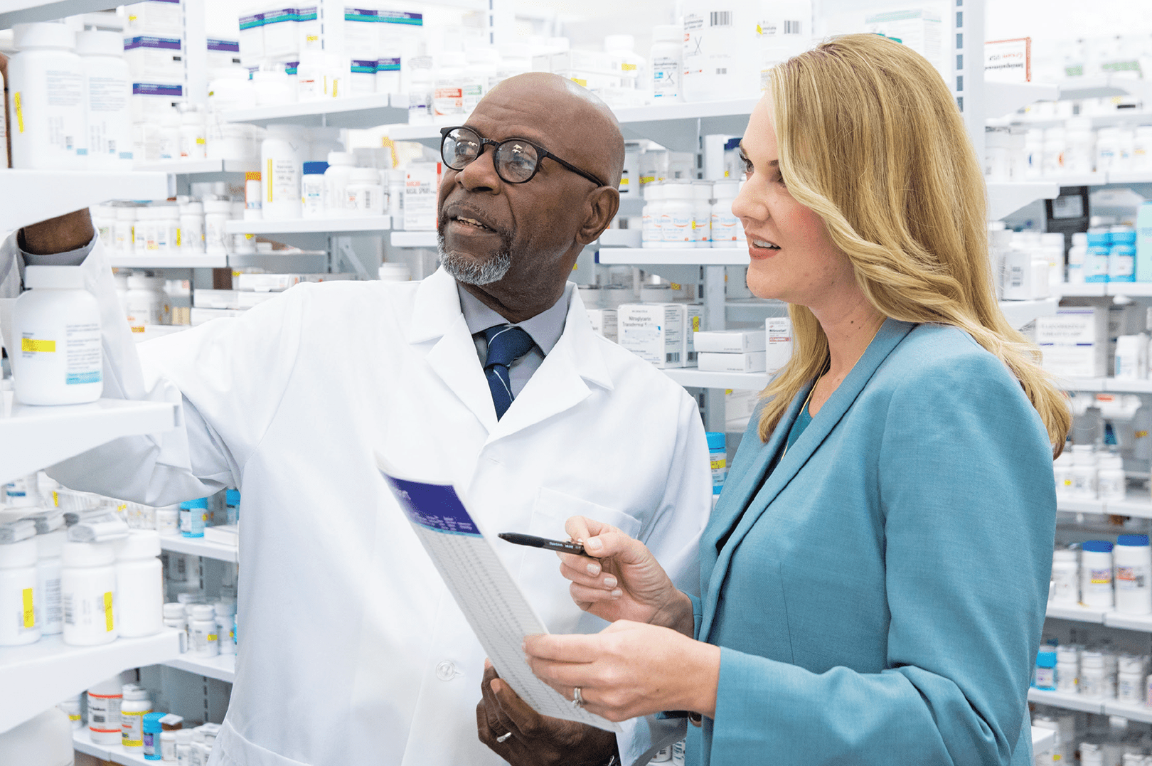 A pharmacy business coach helping an independent pharmacist optimize his inventory